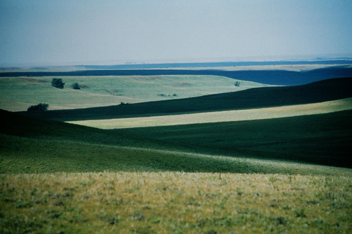 Long green ridges of tallgrass prairie rolling across the Flint Hills in Kansas.